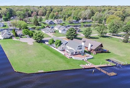 Aerial view of luxury waterfront home situated on Pentwater Lake